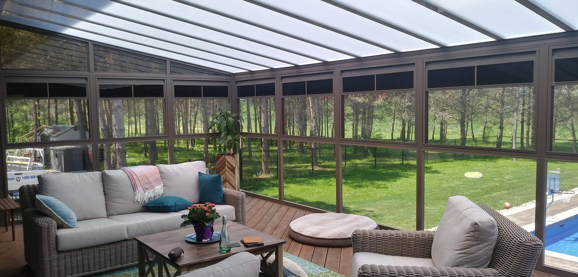 Glazed enclosure with sliding glass walls and a glass roof