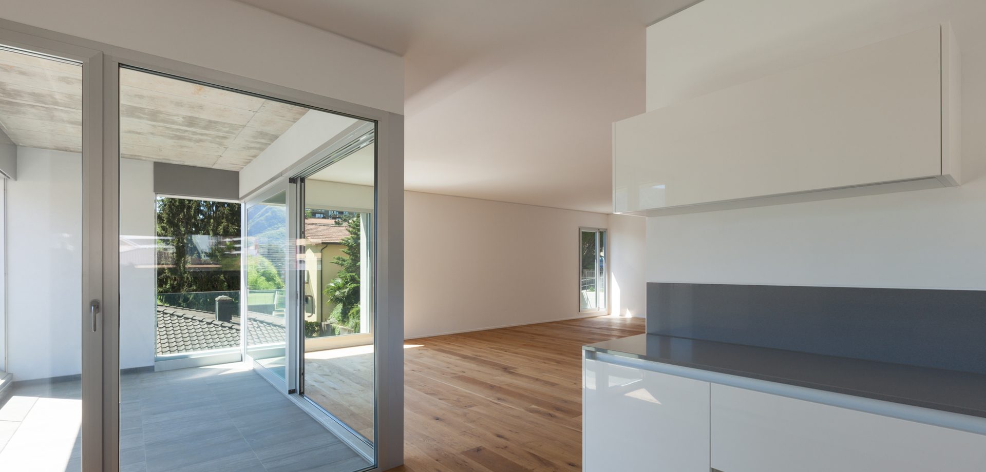 Aluminum sliding glass doors opening a living space to the terrace